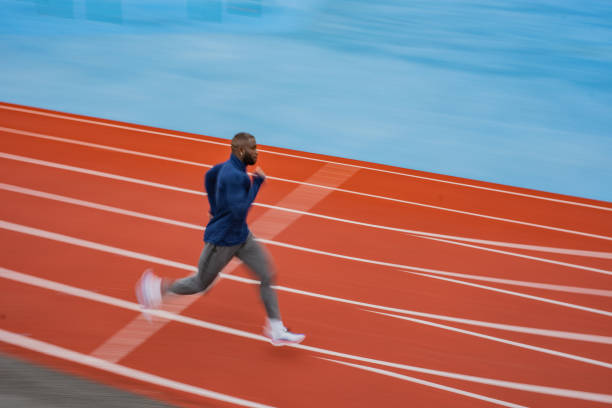 istock Young male athlete running on race track 1316478225