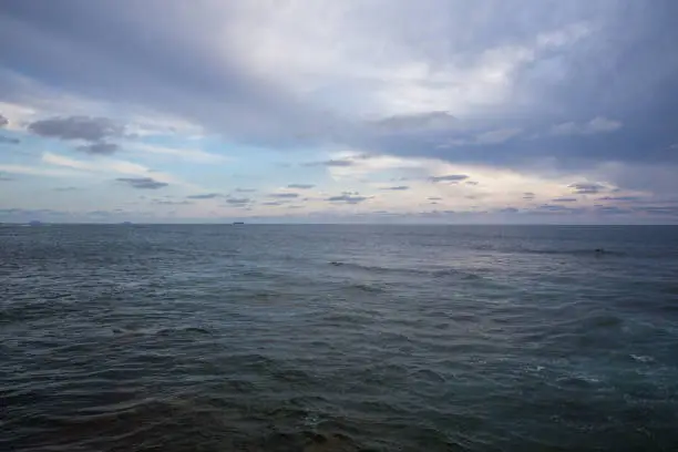 Photo of Calm smooth seawater surface under a beautifully clouded sky