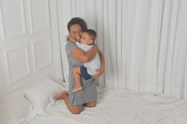 istock mother and son playing on bed 1316479464