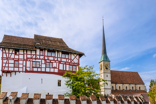 The Castle of Zug, dating to the 11th century, hosts the Zug town and cantonal museum's permanent collection along with other exhibits. At right stands out the clock tower of the St. Oswald church.