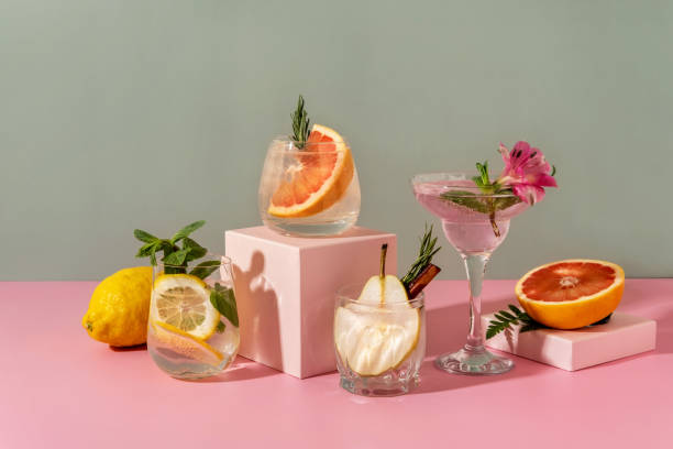 hard seltzer cocktails with various fruits: pear, grapefruit, lemon. refreshing colorful summer drinks on green background. - natureza morta imagens e fotografias de stock