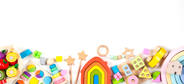 Baby kids toy banner background. Colorful educational toys on white background. Top view, flat lay, copy space