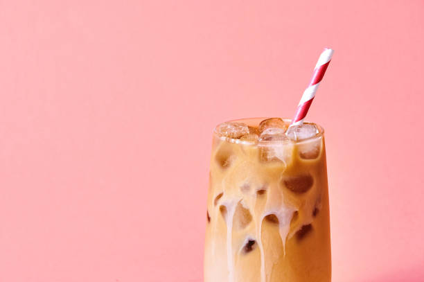 close-up iced coffee with milk in tall glasses on pink background. concept refreshing summer drink - latté imagens e fotografias de stock