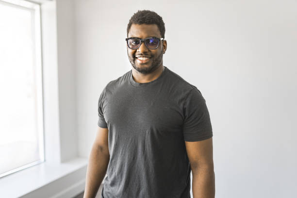 Nice Smiling young man in grey shirt with black glasses,