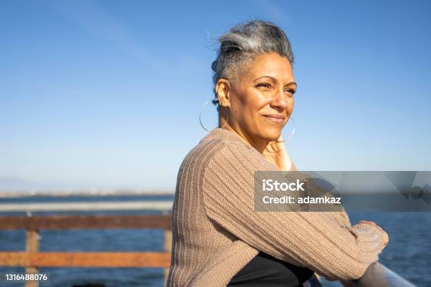 Mature Black Woman Relaxing At The Pier Stock Photo - Download Image Now - One Woman Only, Retirement, Senior Adult
