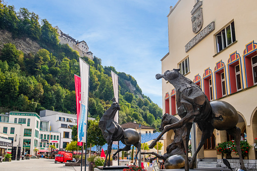 Town hall of Vaduz, the capital city of Liechtenstein. In front of the entrance stands out the bronze sculpture 'Tre Cavalli', work of 2002 by the Swiss artist Nag Arnoldi.