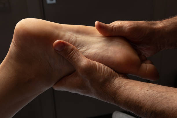 The masseur makes a foot massage The masseur makes a foot massage. Procedure, hands, osteopath, relaxation, care, medicine, mobility, patient, client reflexology photos stock pictures, royalty-free photos & images