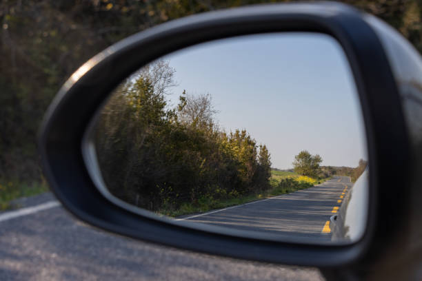 istock Driving on the forest rural road, view from car mirror 1316491566