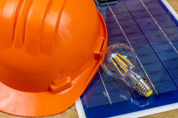 istock photovoltaic panel, led bulb and orange helmet 1316498159