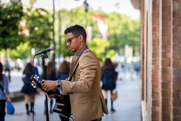 Busker preparing his guitar before playing on the street
