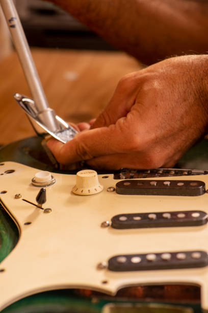 istock luthier working on repairing a guitar 1316500439
