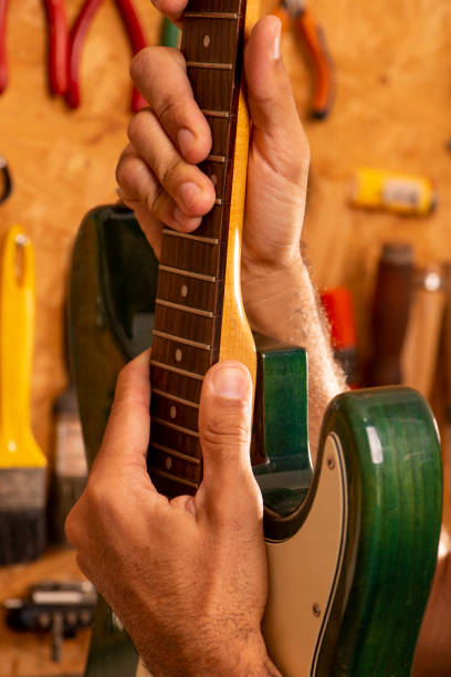 istock luthier working on repairing a guitar 1316500539