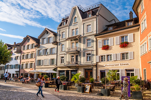 People strolling in the old core of Rapperswil, a beautiful town in the Swiss canton of St. Gallen.