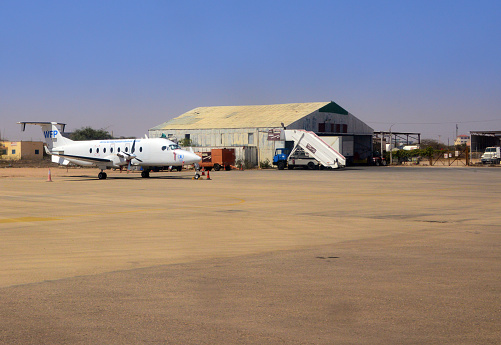 Hargeisa, Somaliland, Somalia: UN World Food Program Beechcraft 1900D (5Y-BVX) parked at Hargeisa Egal International Airport - hangar in the background.
