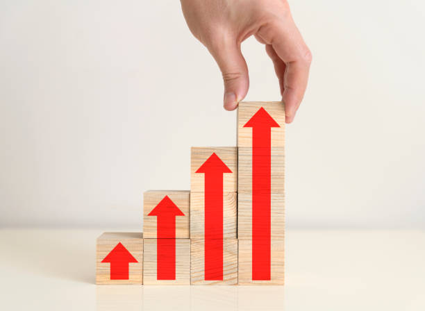 istock Hand Arranging Wood Blocks as Step Stair with Arrow Symbols 1316505696