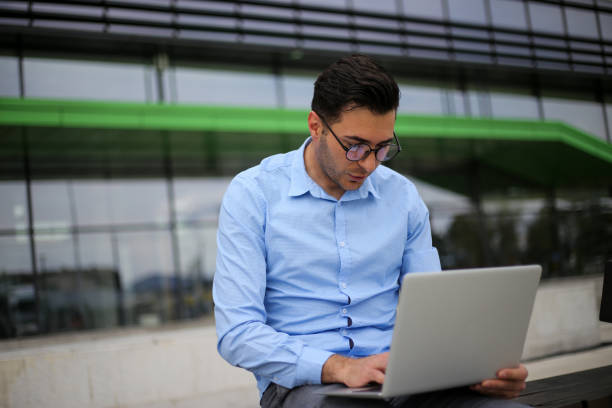 istock Business man using laptop while sitting on the bench. stock photo 1316506867