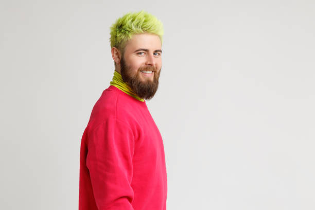 istock Profile of cheerful bearded Caucasian man has happy expression smiles broadly, has white perfect teeth, wears red sweater, looks at camera. Copy space. 1316507139