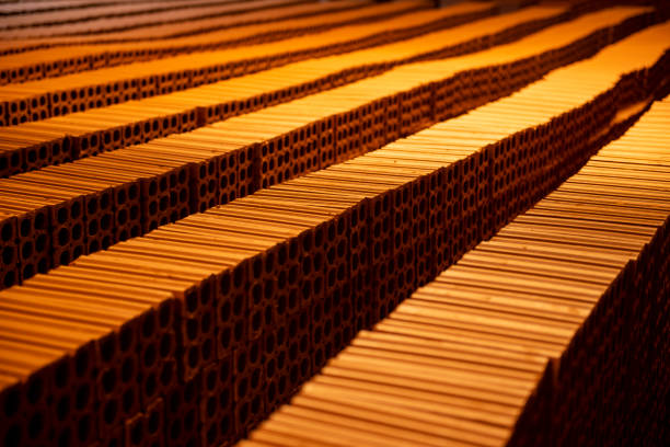 several rows of bricks stacked to dry in a pottery.