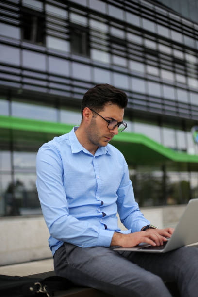 istock Business man using laptop while sitting on the bench. stock photo 1316507313