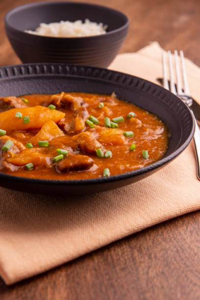 istock plate with cooked cassava and meat on wooden table 1316507449