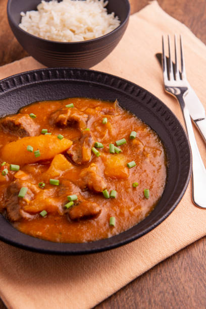 istock plate with cooked cassava and meat on wooden table 1316507538
