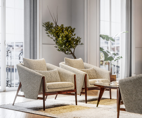 Stylish armchairs in brightly lit living room