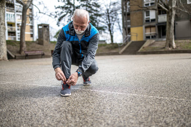 istock Senior sportsman tying shoelaces. 1316509794