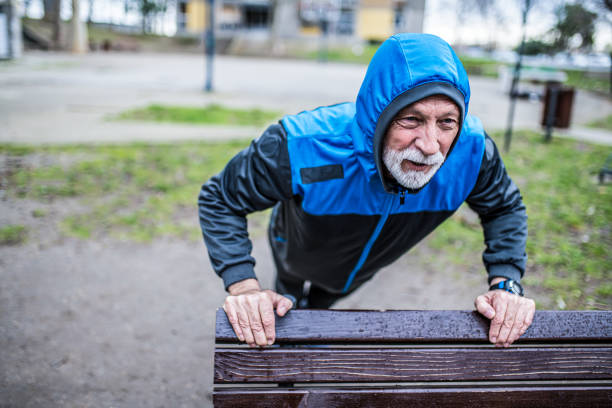 istock Senior man doing push-ups on cold rainy day. 1316510937
