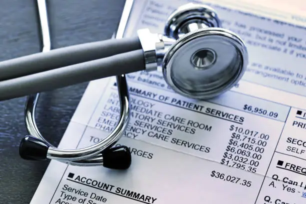 Photo of Stethoscope And Hospital Invoice