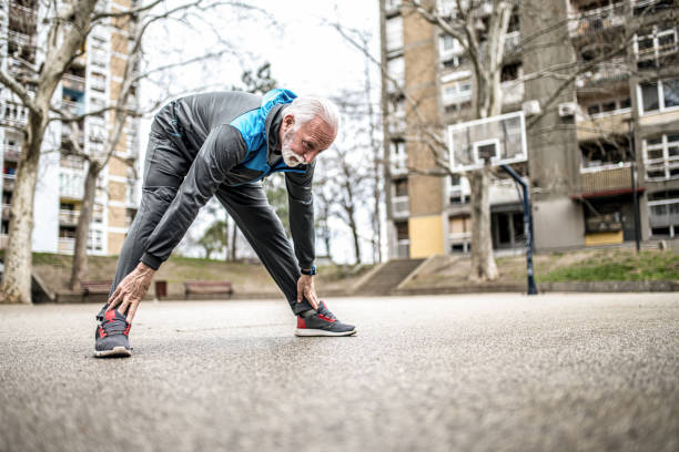 istock Sporty senior man stretching outdoors. 1316512376