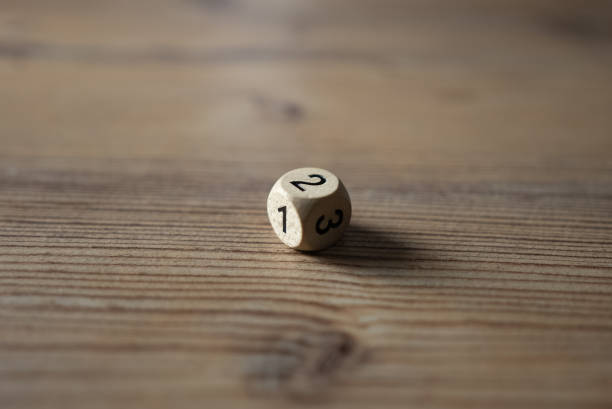 istock Rolling dice on a wooden desk 1316514323