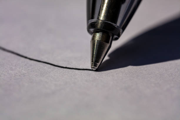 istock Black Ball Point Pen Writing on White Paper 1316518284