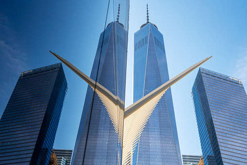 New York, NY, USA - May 29, 2016: Low angle view of One World Trade Center with Part of The Oculus at Transportation Hub for the PATH in New York City, Lower Manhattan, NY, USA