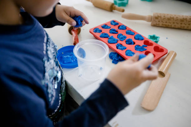 istock Toddler plays with blue plasticine 1316518374