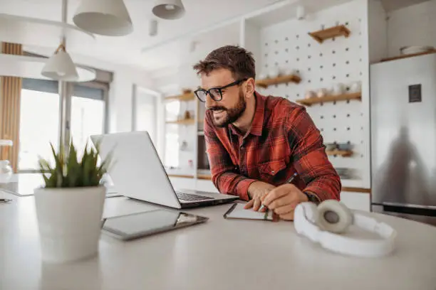 Photo of Young man working from home