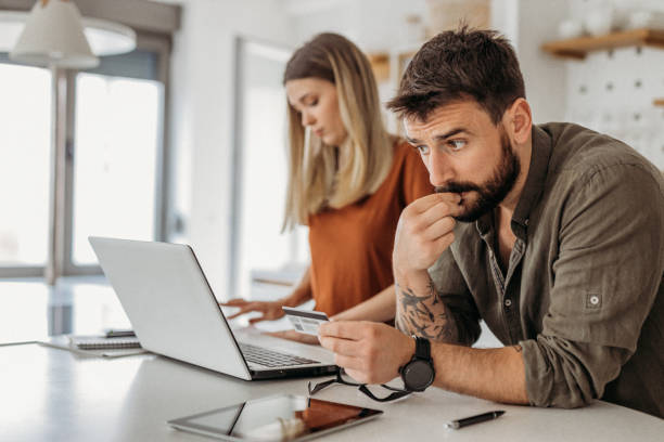 Man looking at his credit card worried