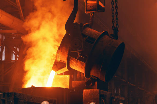 istock Molten metal pour from big container Into sand mold with sparks. Iron casting in metallurgy foundry plant, heavy industry 1316523520