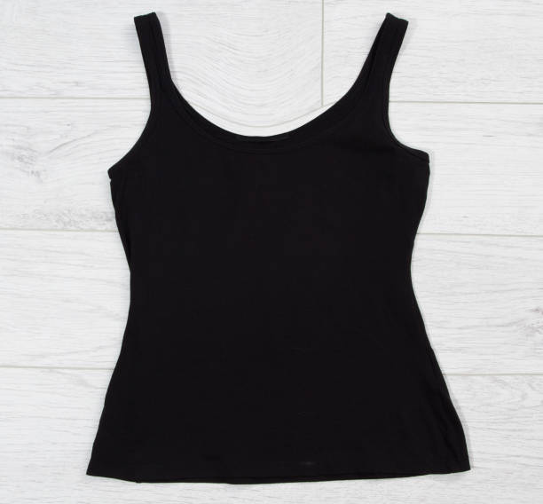 istock Black tank top tshirt template mock up on white wooden background top view. 1316523742