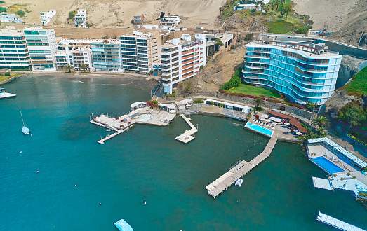 Aerial view of the bay, marina and buildings of Ancon - Lima, Peru; Summer area, The beach and some exterior buildings in Ancon.
