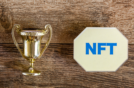 Turning an artwork into Non Fungible token (NFT) concept with a trophy on one side and a symbolic NFT token on the other side. This way rare items can be traded in ETH blockchain as virtual assets