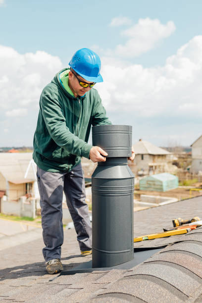 istock male worker with blue helmet installs an iron chimney. 1316532161