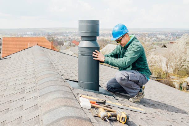 istock male worker with blue helmet installs an iron chimney. 1316532245