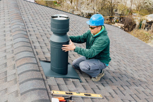 istock worker with blue helmet on the roof installing iron chimney. 1316532254