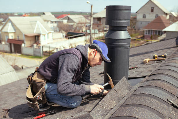 istock a professional master roofer with hammer repairs the roof. 1316532906