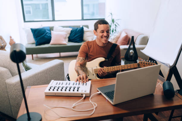istock Young man recording guitar and keyboard at home studio 1316533042