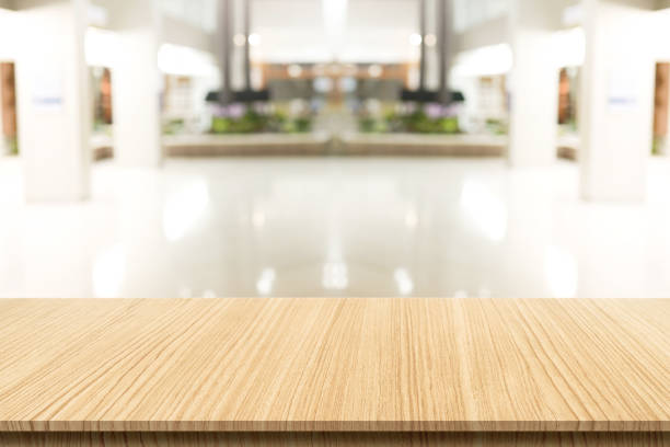 istock Empty wooden table in front of a blurred background. Brown wood in blurry view in office work - can be used to display or edit your products, simulate to showcase them. 1316534845