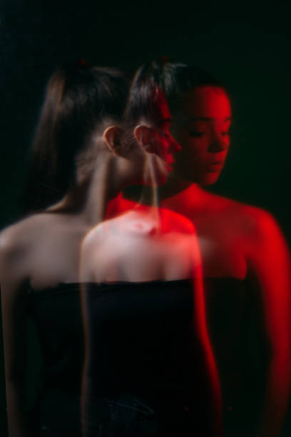istock female duality double exposure woman in red light 1316541633