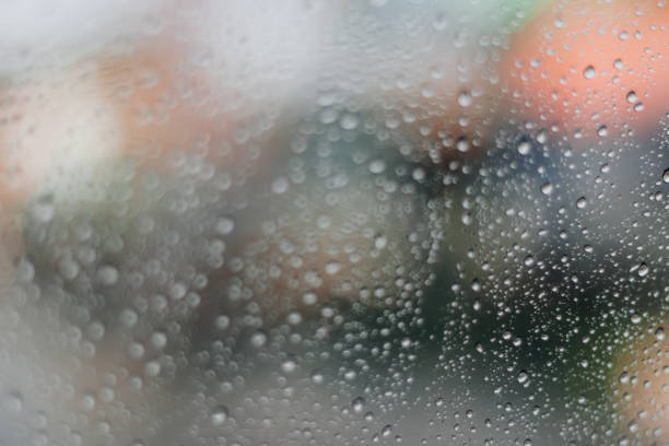istock Blurred rainy window with red bokeh light 1316545325