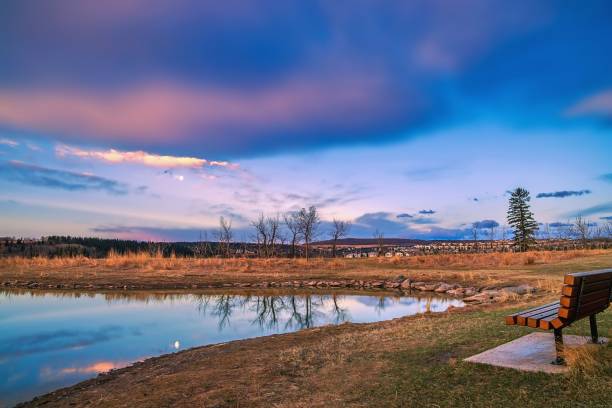 Cloudy Sunrise In A Spring Park A bright cloudy sky over a spring park in Cochrane. cochrane alberta photos stock pictures, royalty-free photos & images