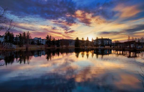 istock Sunrise Clouds Reflecting In A Spring Park Lake 1316546119